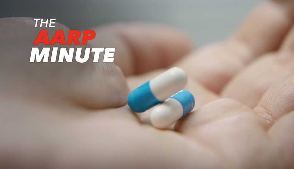 a hand holding two pills