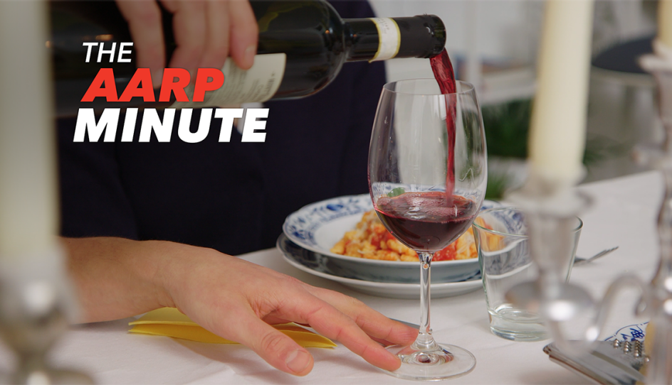 a person pouring a glass of red wine