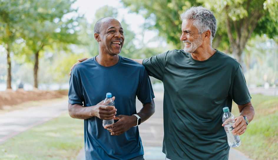 Senior friends walking in public park