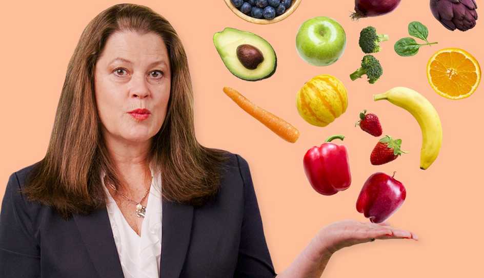 a woman holding out her hand with fruit and vegetables falling onto it