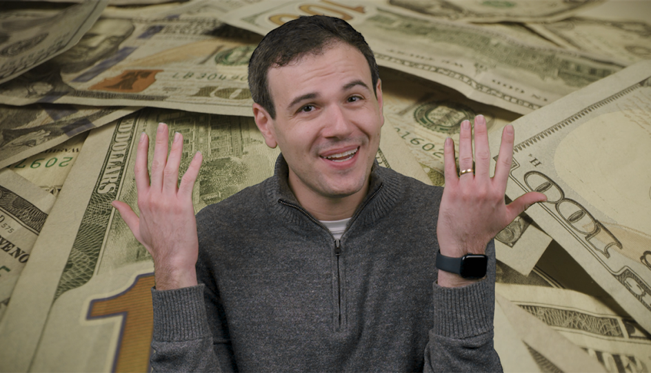 a man holding his hands up with money behind him