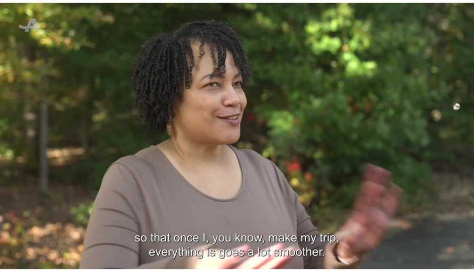 Woman being interviewed about her travel experiences.