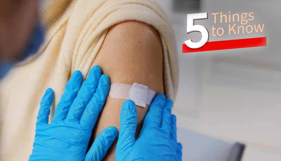 a person is getting a band aid placed on their upper arm