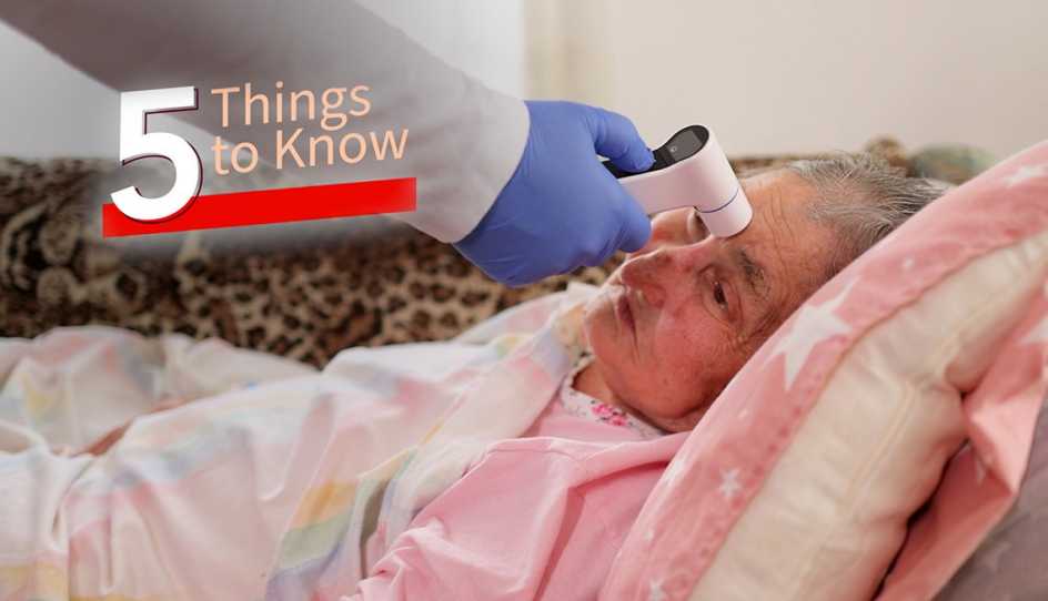 a woman has her temperature checked