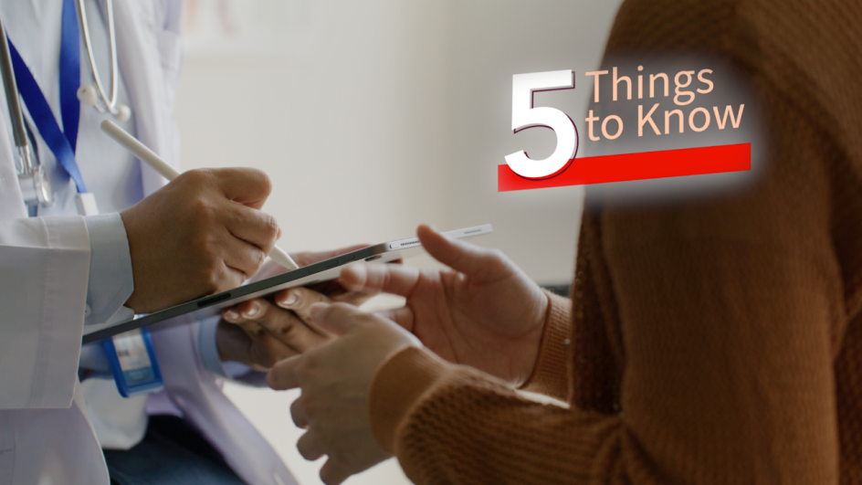 a doctor writing on a tablet across from a person with gloved hands