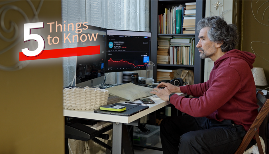 a man working on his computers from on office