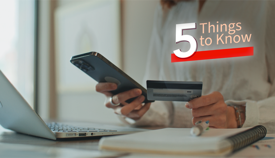 a person on a phone with a credit card in their hand