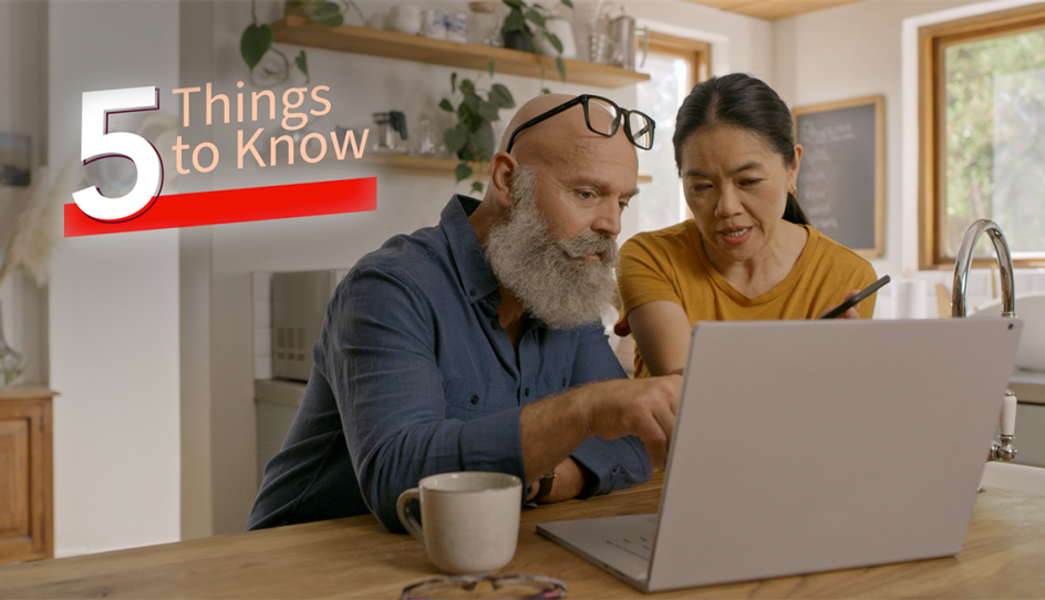 a man and woman looking at a computer screen