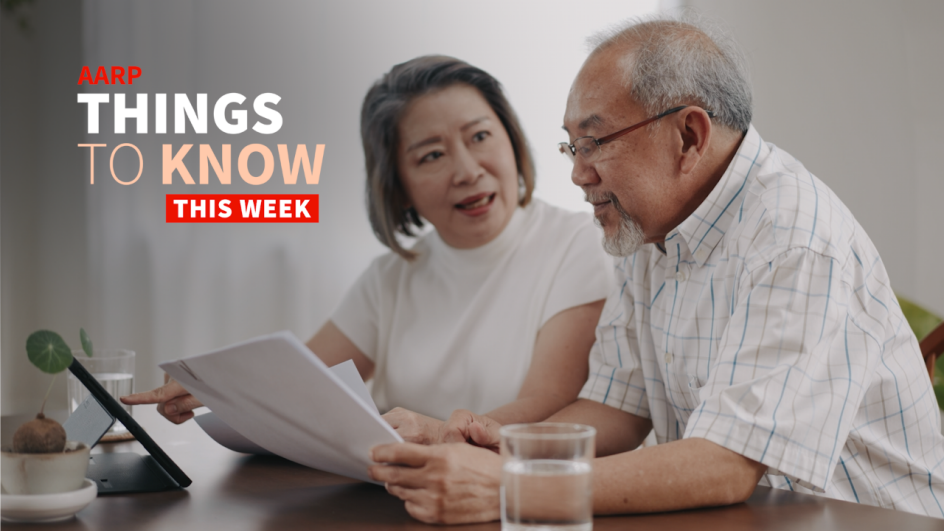 A man and woman sitting at a table holding papers