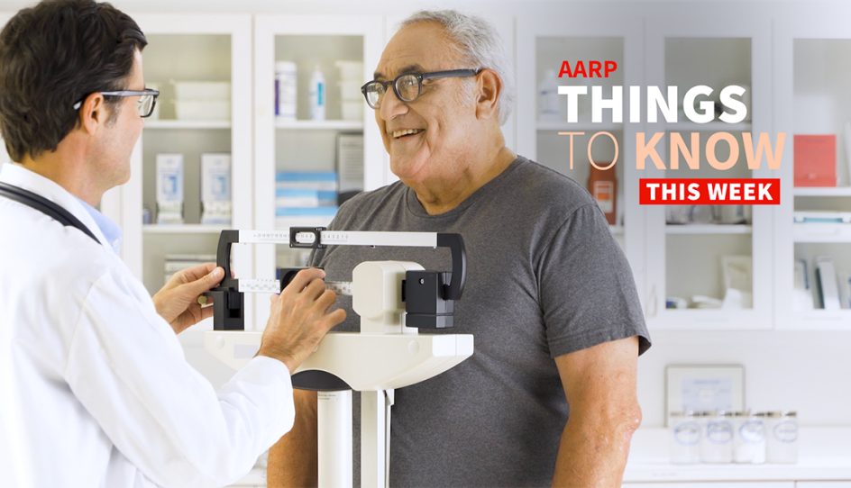 a man getting his weight checked on a scale by a doctor