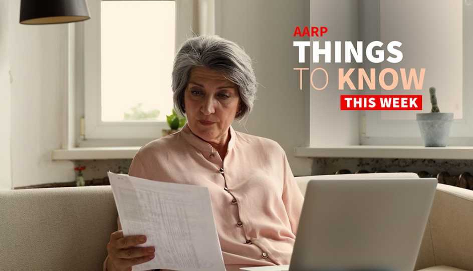 a woman is sitting on her couch looking at paperwork