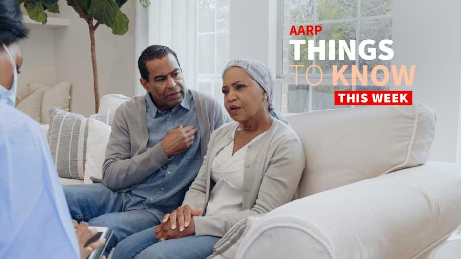 a photo shows an older adult couple on a couch consulting with a medical professional