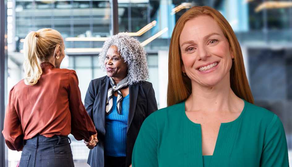 a woman standing in front of two women shaking hands