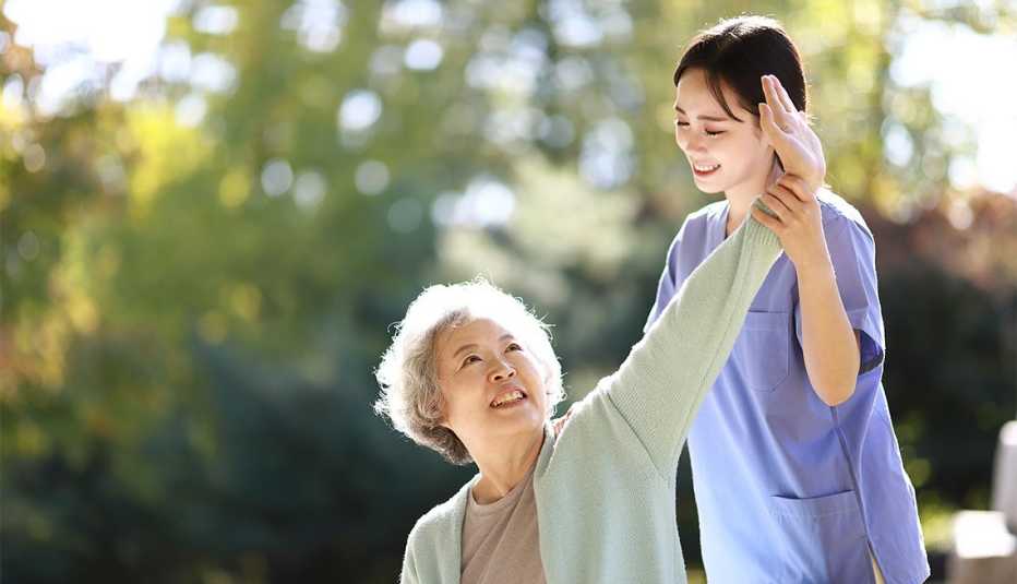nurse helping woman stretch