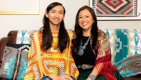 sheila lopez and emanuel one of her children sit on a couch in their home