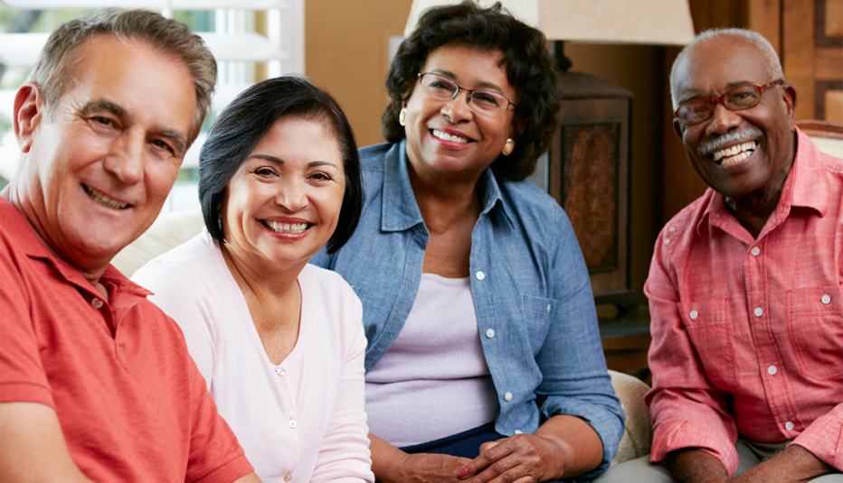 Portrait Of Friends At Home Together Smiling To Camera group of four adults smiling