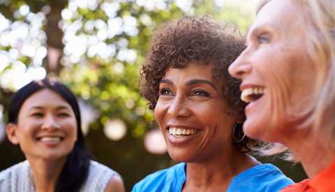 three women smiling outdoors three women smiling outdoors