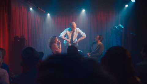 two men and woman on stage doing improv two men and woman on stage doing improv