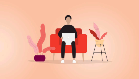 person on computer sitting on red couch with plants to each side person on computer sitting on red couch with plants to each side