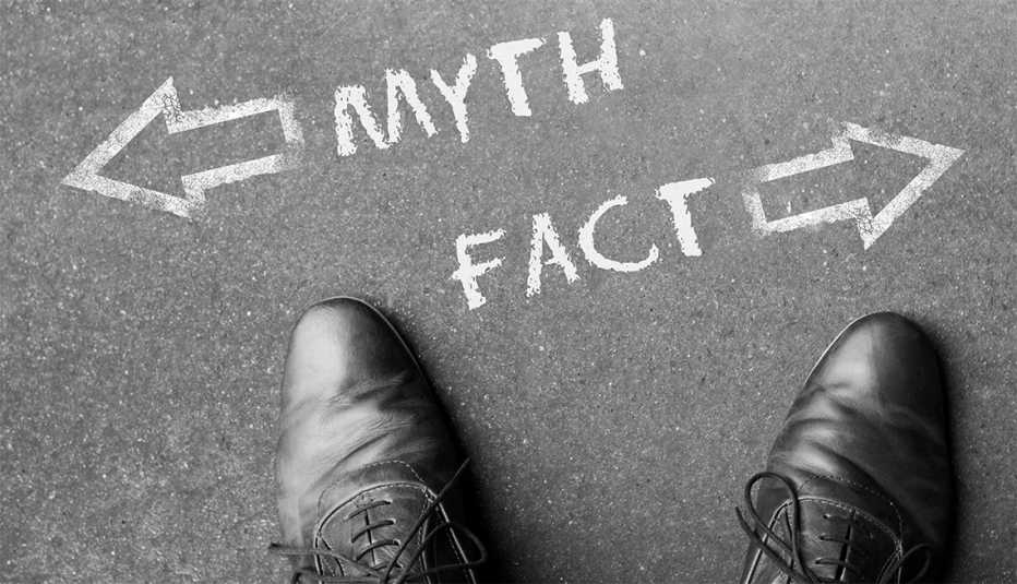 a pair of mens dress shoes shot from the point of view of the man looking down with . the words myth and fact written in chalk on the street in front of him