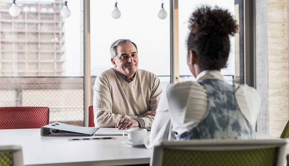 man and woman sitting at conference table