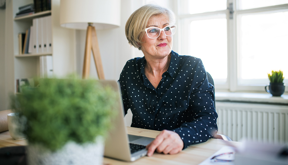 A woman is working on her laptop from home