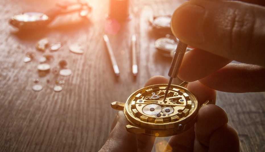 watchmaker's hands repairing a mechanical watch