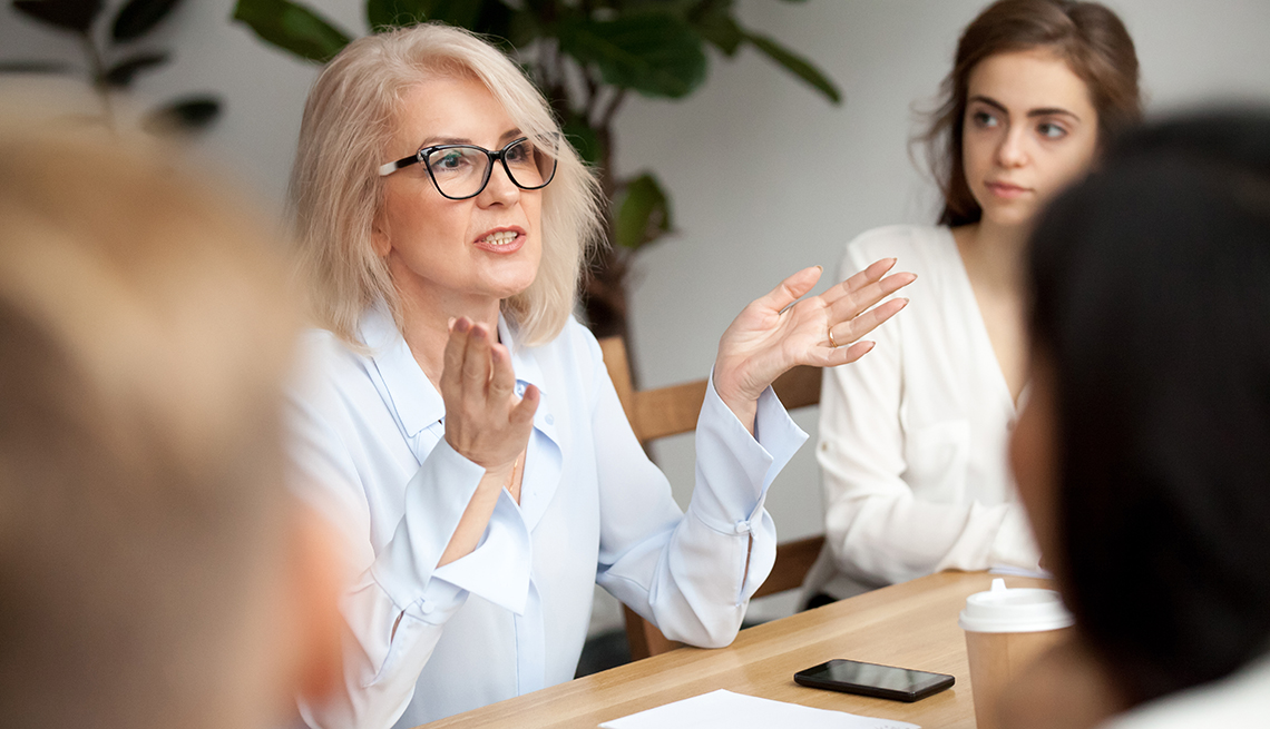 a woman talks in a meeting