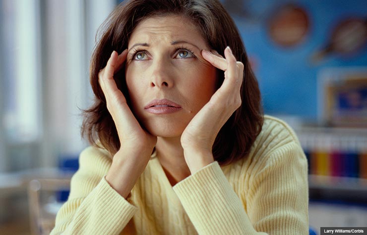 Woman rubbing temples, Medications that cause memory loss