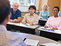 Kick Start Your Career - Mature female student raising hand in class