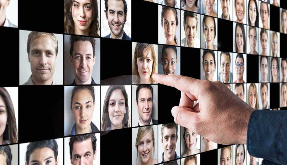 A person is pointing to a face on a screen