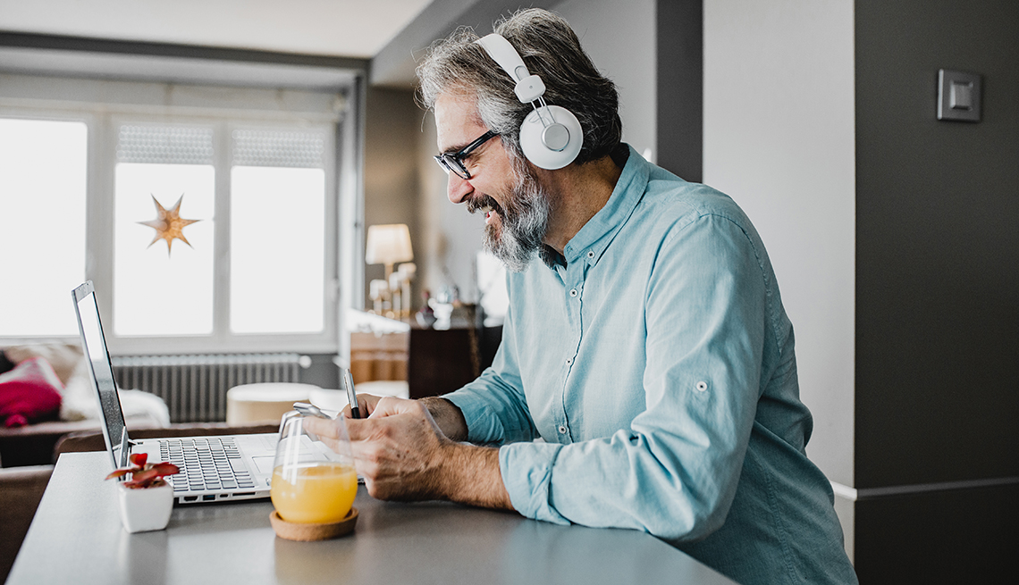 A man is working from home at a table