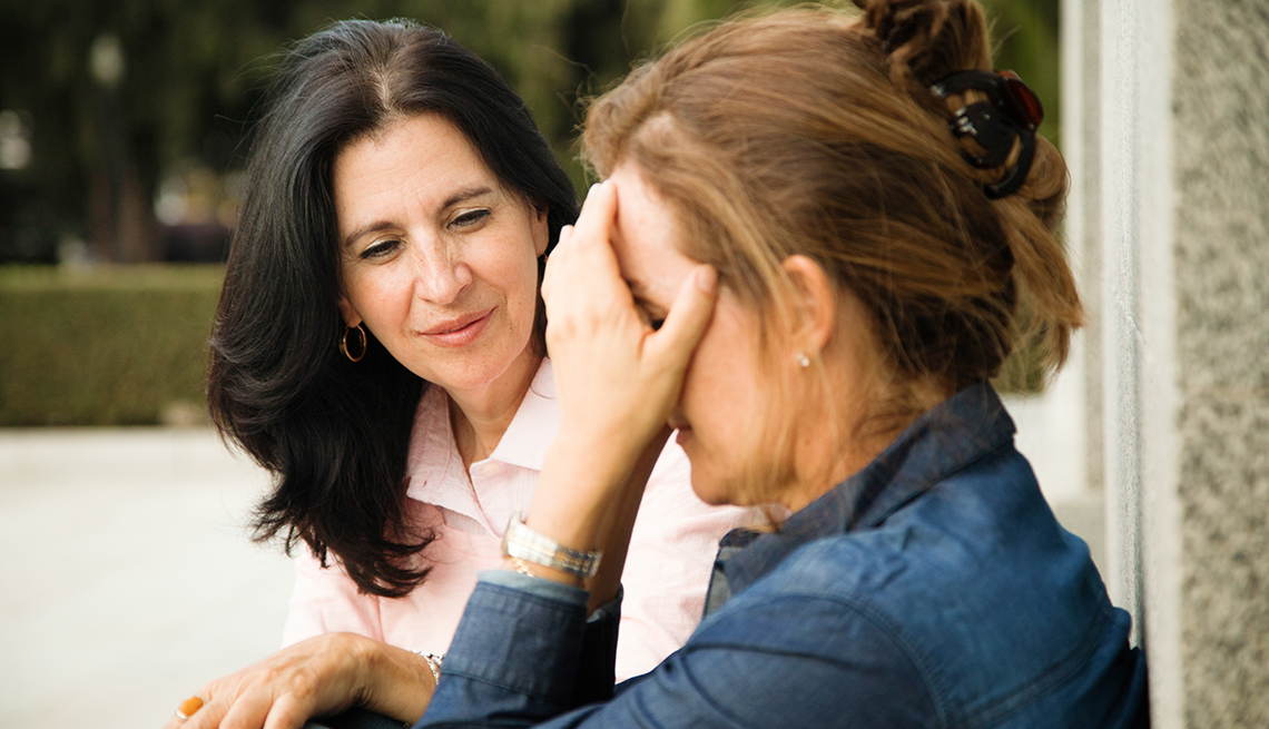 A woman is consoling her friend