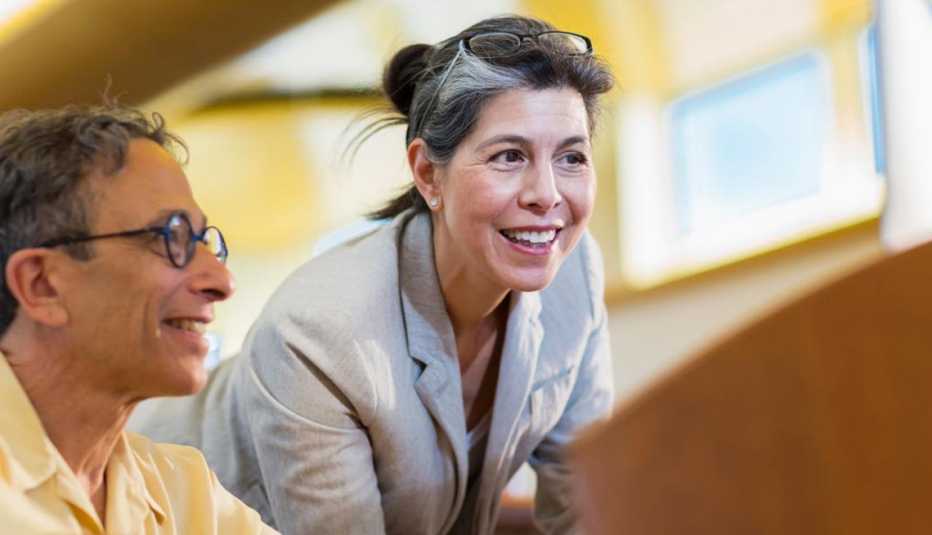 Mature Man and Woman collaborating at a desk, Thinking of Changing Careers, 