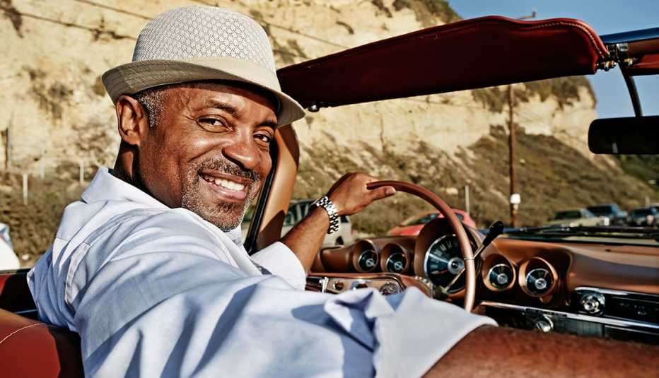 mature black man driving a car