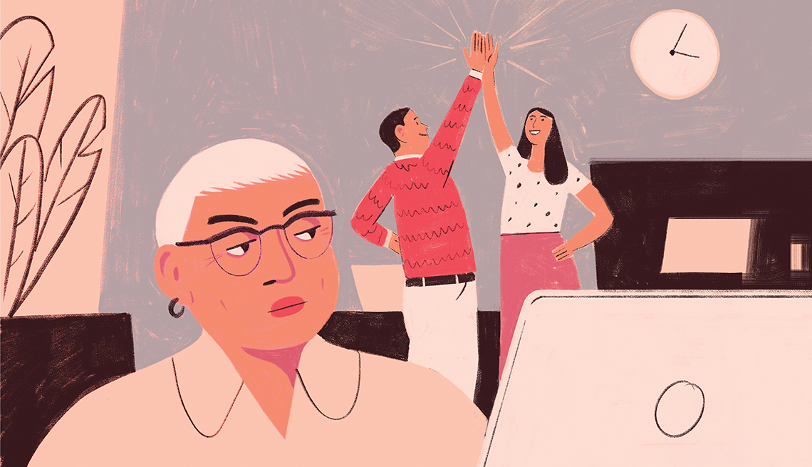 a woman working in an office frowns as two people high five each other in the background
