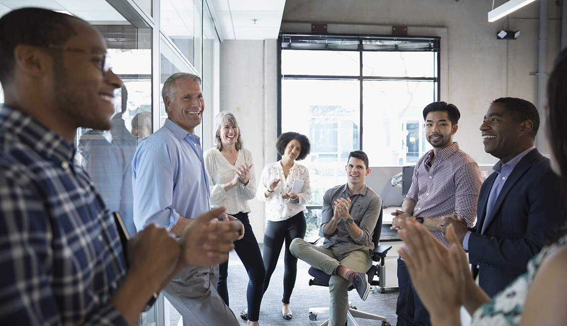group of people standing in an office