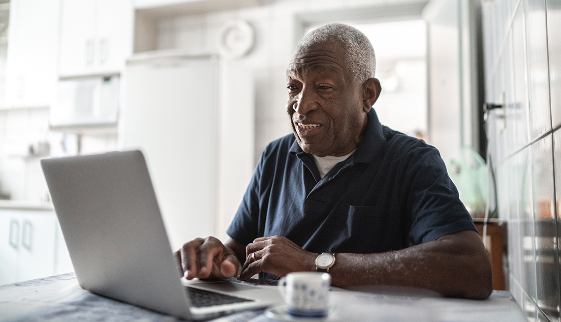 A man working from his kitchen table