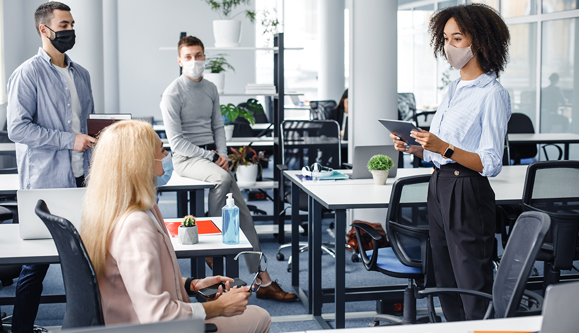 Four people in a meeting room