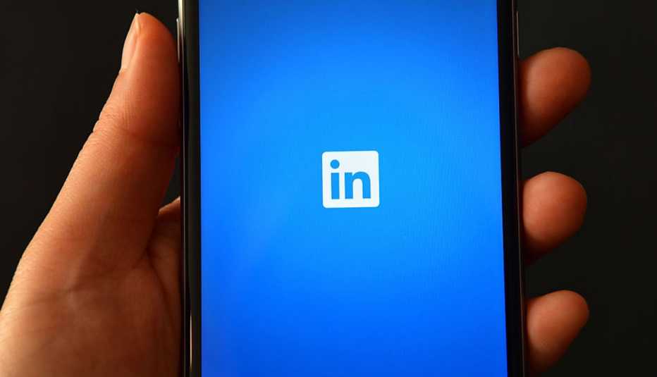 Person holding smartphone showing Linkedin logo, Job Seekers, 