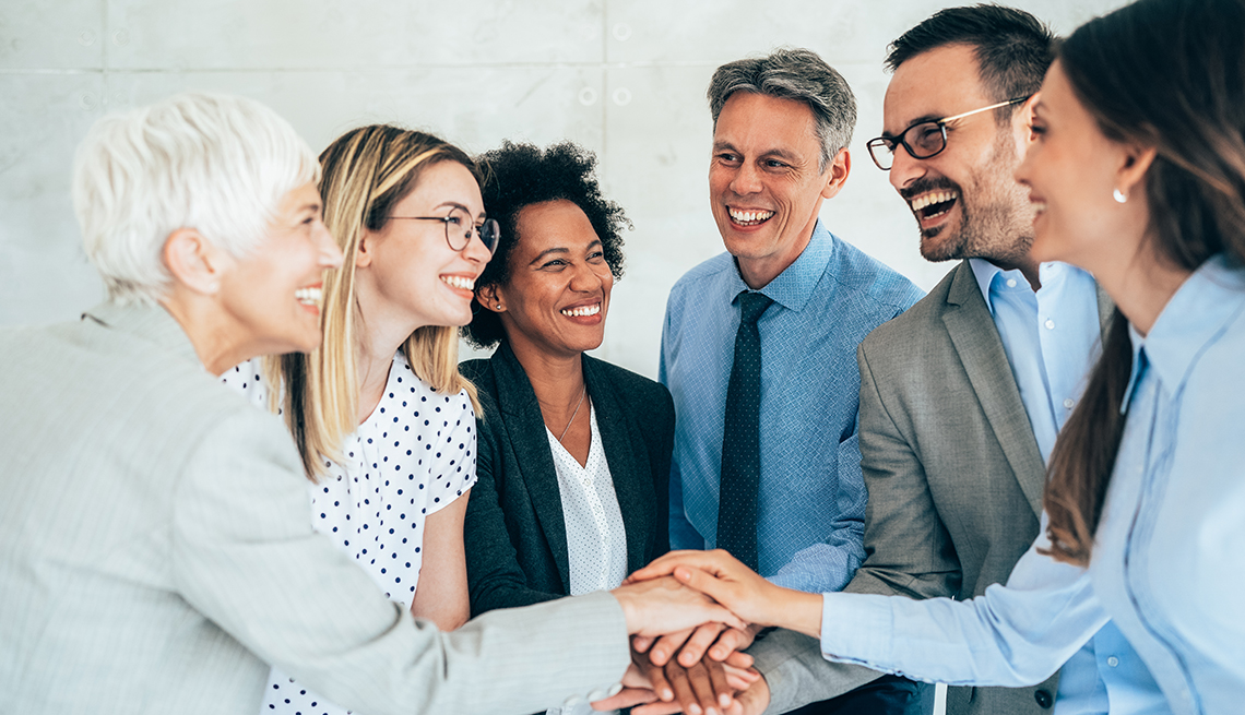 an age-diverse group of colleagues gathers together