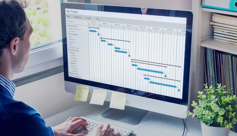 A man looking at a spreadsheet on his computer