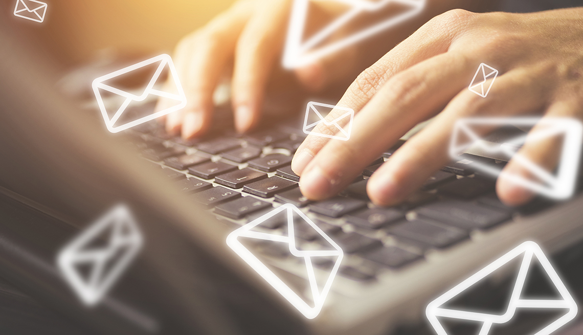 close up of a woman's hands working on a laptop keyboard sending out email letters