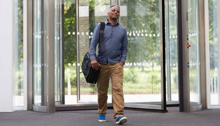 a man walks into the lobby of a modern building