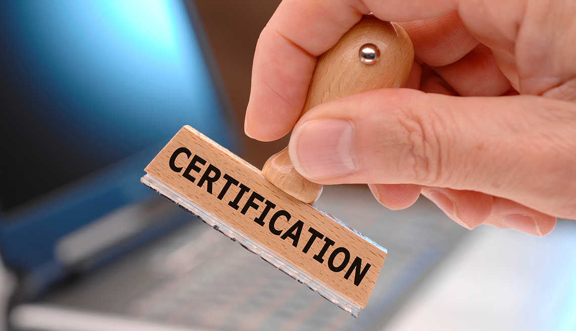 hand holding a rubber stamp that says certification on the side