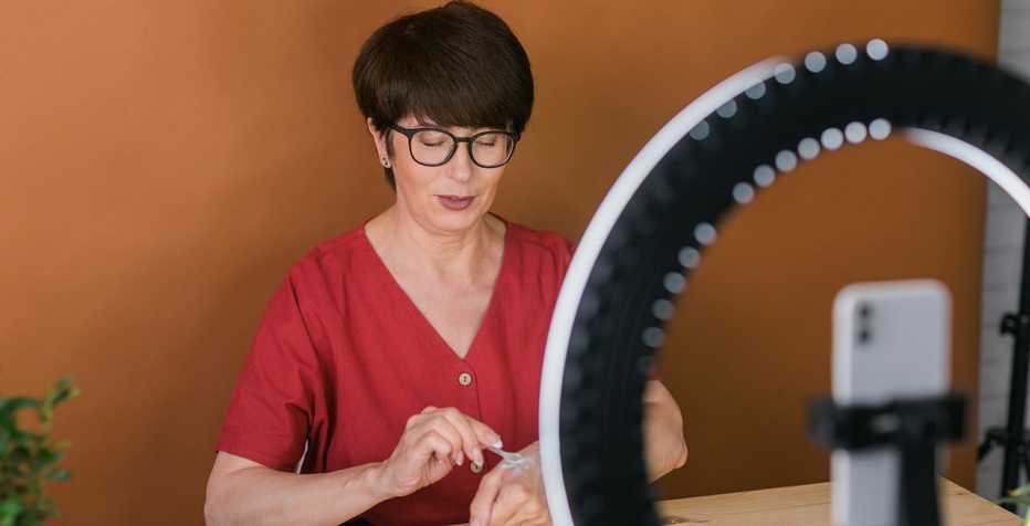 a woman demonstrates an activity in front of a smartphone