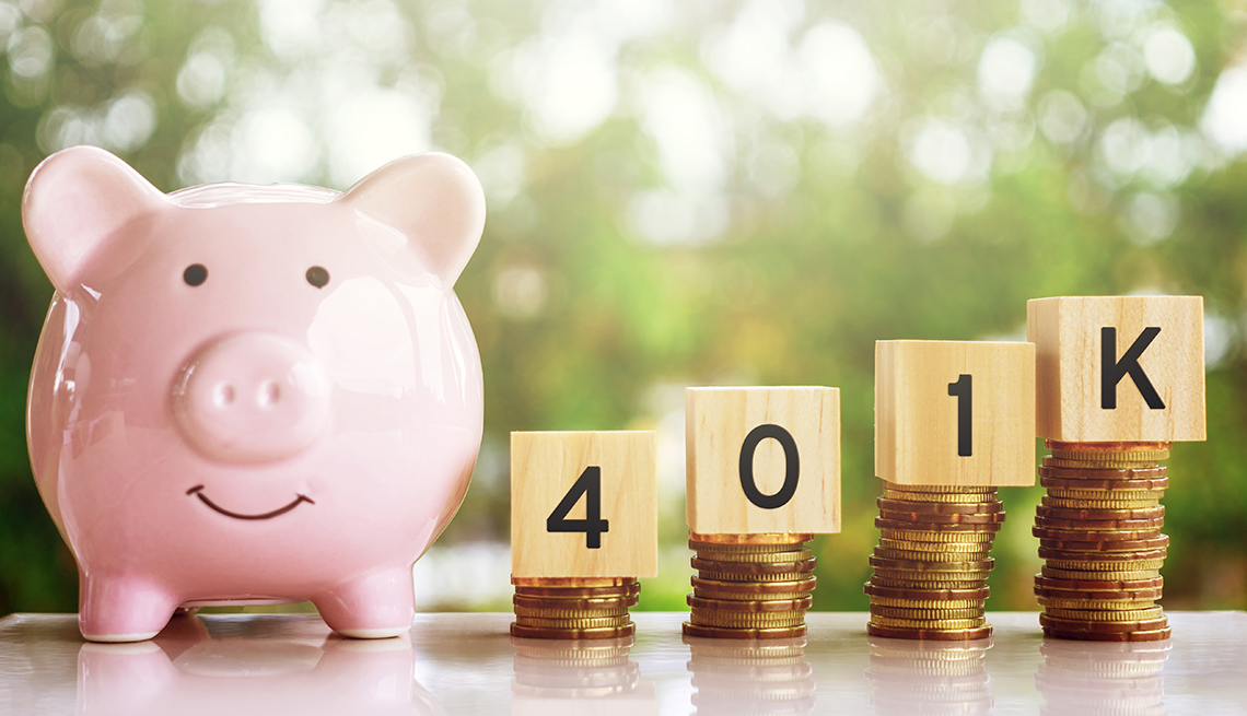 A piggy bank with coins and blocks that spell out 401K