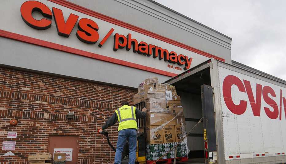 A worker unloads a truck at C V S