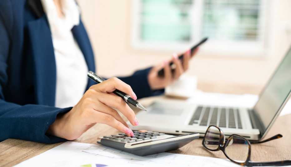 woman working on laptop and calculator