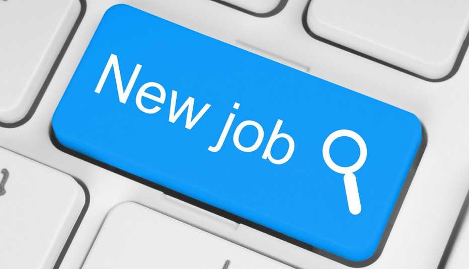 A blue button on a white keyboard with the word new job